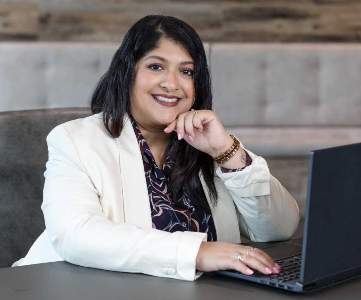Encore Studio photography. Business headshot. Woman at computer.